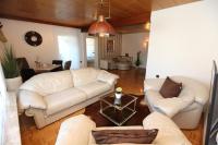 a living room with two white couches and a table at Pension Gockels-Auszeit in Bad Wildungen