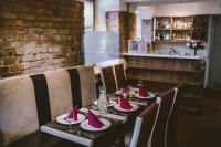 a dining table with pink napkins on it in a restaurant at Hanza Hotel in Rīga