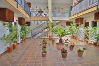 a courtyard with potted plants and stairs in a building at Hotel Posada Casas Viejas in Benalup Casas Viejas