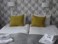 Posteľ alebo postele v izbe v ubytovaní Carina Hotel