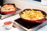 a bowl of french fries and a pan of ketchup at Ramada by Wyndham Jeju City Hall in Jeju