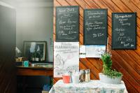 a table with a chalkboard on a wall with a table with a tableablish at Ferien Weingut Schneider in Ellenz-Poltersdorf