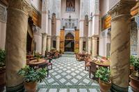 an interior view of a building with tables and chairs at Dar victoria in Fès