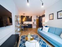 Televízia a/alebo spoločenská miestnosť v ubytovaní Apartament DWIE SOSNY