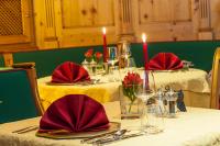 a table with two tables with red napkins and candles at Impuls Hotel Tirol in Bad Hofgastein