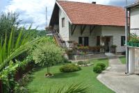 a house with a yard with flowers and plants at Apartmani Mali Raj Rudnik in Rudnik