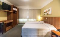 Tri Hotel Executive Caxiasにあるベッド