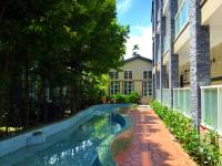 a swimming pool in front of a building at Champs Yazuh B&amp;B in Jiji