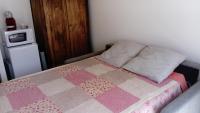 a bedroom with a bed with a quilt on it at Chez Elisa in Chinon