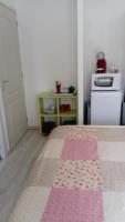 a bedroom with a bed with a pink and white rug at Chez Elisa in Chinon