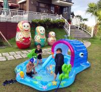 two children playing in an inflatable pool in a backyard at Sophia B&amp;B in Dongshan