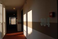 an empty hallway with a door and a hallway at Temporesidence Cathedrale in Bayonne