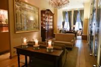 a living room with two candles on a table at Hotel Le Dixseptième in Brussels