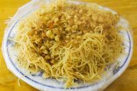 a plate of spaghetti and chickpeas on a table at Apple Tree Bed and Breakfast in Hualien City