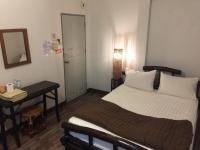 Postel nebo postele na pokoji v ubytování Lamphuhouse Bangkok