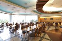 a restaurant with tables and chairs and large windows at Ark Hotel Okayama -ROUTE INN HOTELS- in Okayama