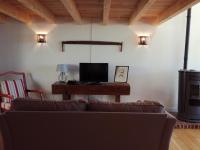 a living room with a couch and a television at Gîte du Besset in Pradelles