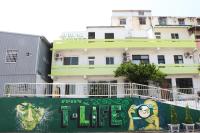 a building with a mural on the side of it at T-Life Hostel in Longjing