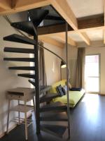 a loft bed with a spiral staircase in a room at Blackbird´s Nest in Wiesenbronn