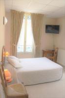 a bedroom with a white bed and a window at Hôtel De France in Chalabre