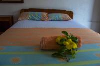 a bedroom with a bed with a flower arrangement on it at Hotel Sol Puntarenas in Puntarenas
