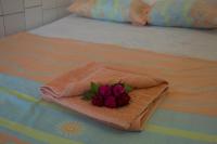 a bouquet of flowers sitting on top of a bed at Hotel Sol Puntarenas in Puntarenas