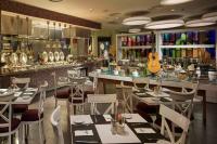 a restaurant with tables and chairs and a guitar at Hard Rock Hotel Penang in Batu Ferringhi