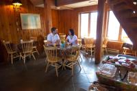 a man and woman sitting at a table in a restaurant at Kandahar Lodge at Whitefish Mountain Resort in Whitefish