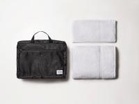 a black bag and towels on a white background at The Millennials Kyoto in Kyoto
