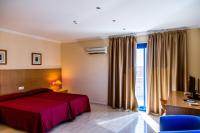 A bed or beds in a room at Hostal Casa Manolo