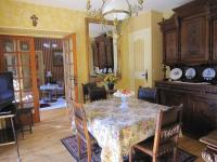 a dining room with a table and a mirror at La Maison de Mireille in Le Puy-en-Velay