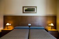 A bed or beds in a room at Hostal Casa Manolo
