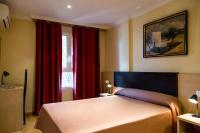 A bed or beds in a room at Hostal Casa Manolo