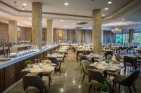 a restaurant with tables and chairs and a bar at Pavlo Napa Beach Hotel in Ayia Napa