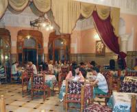 a group of people sitting at tables in a restaurant at Hôtel Transatlantique in Casablanca