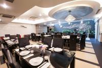 a restaurant with tables and chairs in a room at Chiayi King Hotel in Chiayi City