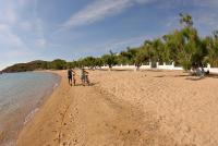 a couple of people riding bikes on a beach at Coralli Seaside Resort in Livadakia