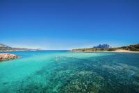 a view of a beach with blue water at Hotel Ollastu in Costa Corallina