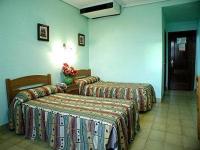 Postel nebo postele na pokoji v ubytování Hotel Los Nogales