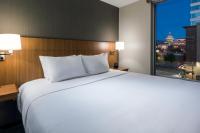 a large white bed in a hotel room with a window at Hyatt Place Boise/Downtown in Boise