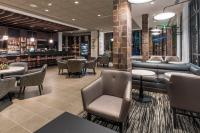 a restaurant with tables and chairs and a bar at Hyatt Place Boise/Downtown in Boise