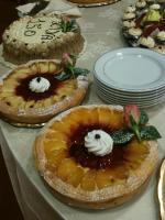 a table topped with pies with fruit and whipped cream at Savant Hotel in Lamezia Terme