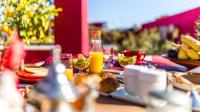 a table with plates of food and drinks on it at Riad Dar Karma in Marrakech