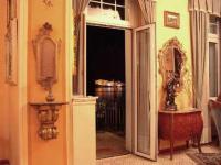 an open door to a room with a mirror at Hotel Villa Ruscello in Baveno