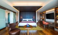 a bedroom with a bed and a table and a tv at The Prince Gallery Tokyo Kioicho, a Luxury Collection Hotel in Tokyo