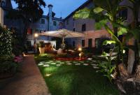 a garden at night with an umbrella and grass at Hotel Abbazia in Venice