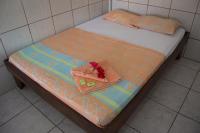 a bed with a purse on top of it at Hotel Sol Puntarenas in Puntarenas