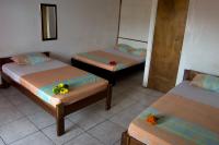 a room with three beds with flowers on them at Hotel Sol Puntarenas in Puntarenas
