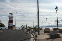 a red and white lighthouse sitting next to a street at Hotel Sol Puntarenas in Puntarenas