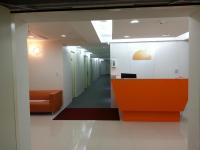 an office lobby with an orange and white reception desk at Morwing Hotel Fuzhong in Taipei